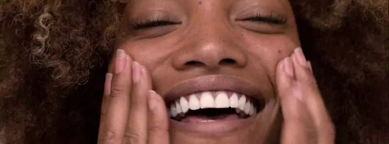 brown girl massaging her face and smiling main-post-image