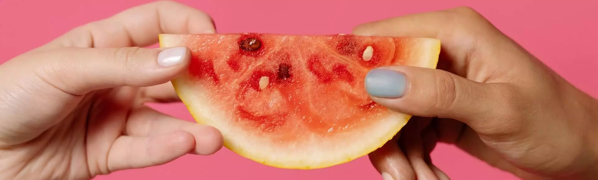 hands holding a piece of watermelon main-post-image