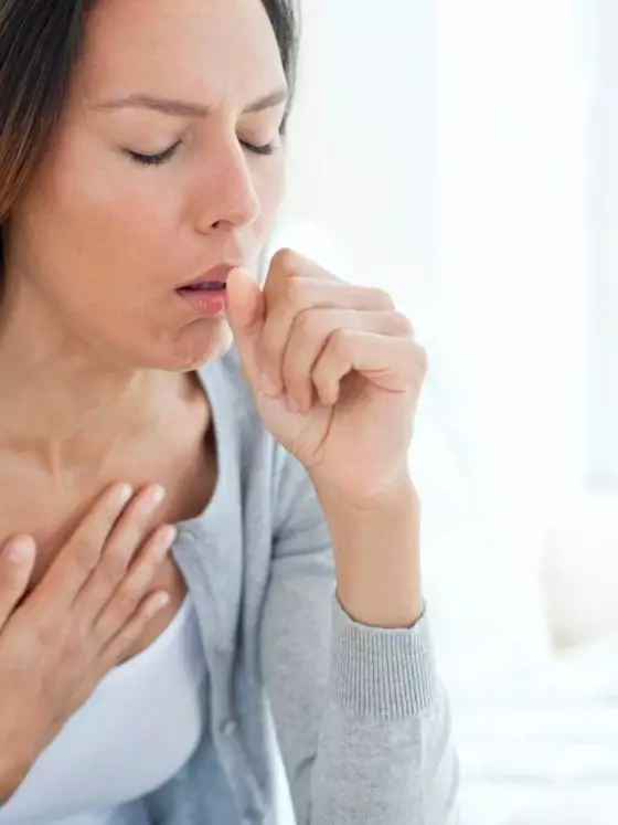 woman coughing and holding her chest thumb image